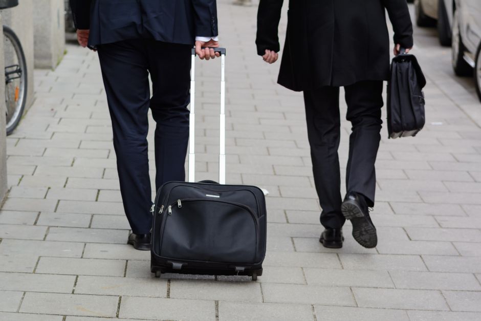 Een zakelijk persoon op reis met een laptop en documenten